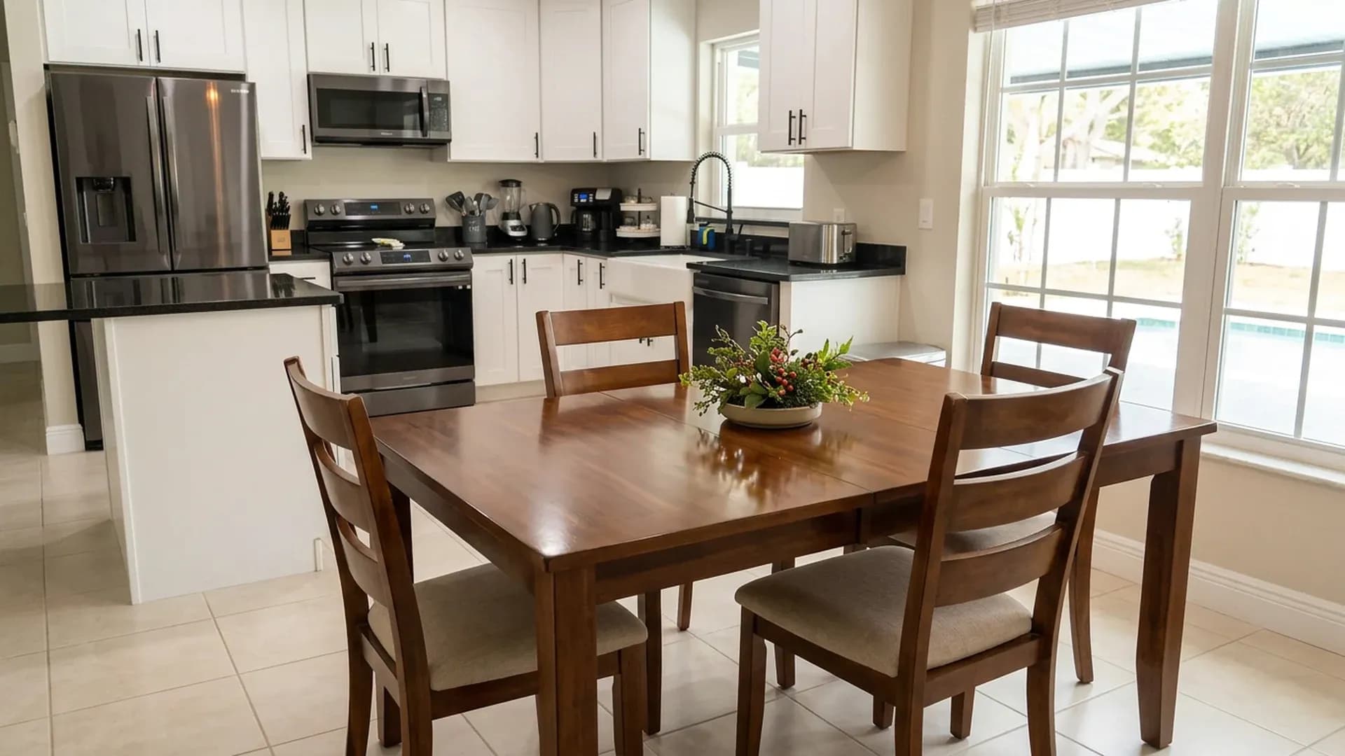 Clean Florida dining room with a wooden table opening onto a bright kitchen before holiday guests arrive.